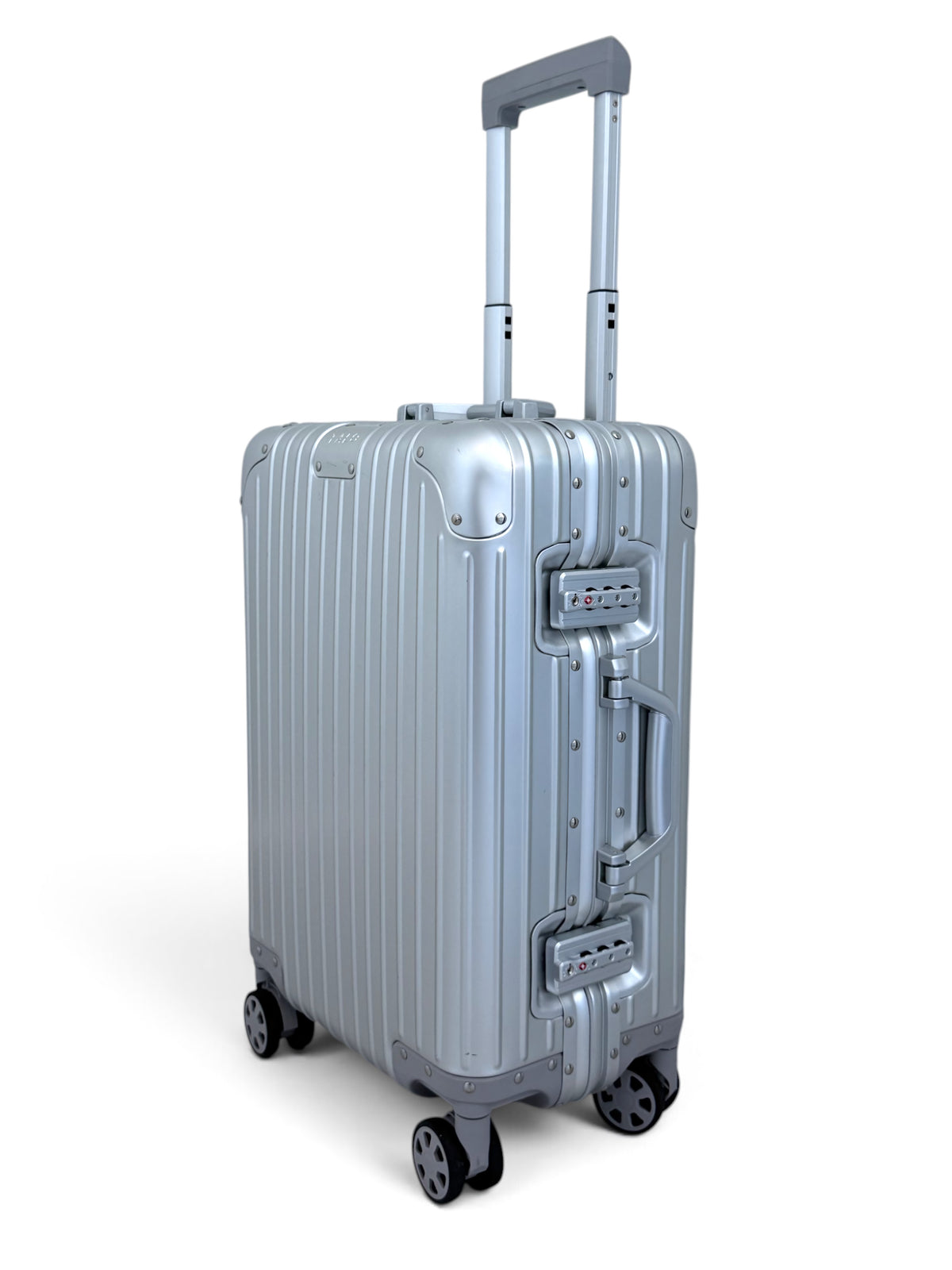 Talo 20-inch carry-on luggage in silver ribbed aluminum with TSA frame latches and silent spinner wheels.
